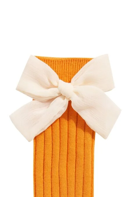 Orange knee socks with a cream bow