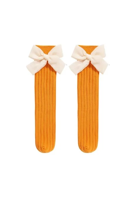 Orange knee socks with a cream bow for a girl
