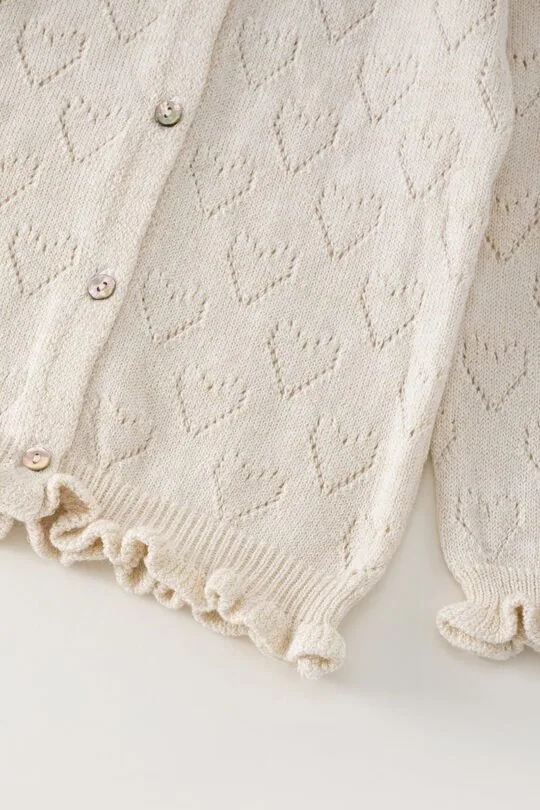 white girly sweater cardiga with hearts bottom detail