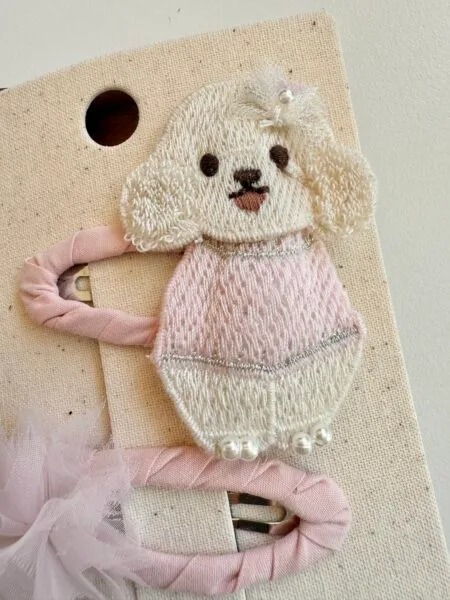 Clips for a girl with an embroidered puppy in pink and white, decorated with pearls.